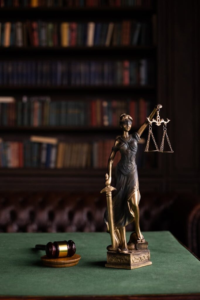 The Legal Landscape of Marriage: Arguments Against Criminalizing Marital Rape in India Lady Justice and gavel on a table in a classic law library setting.